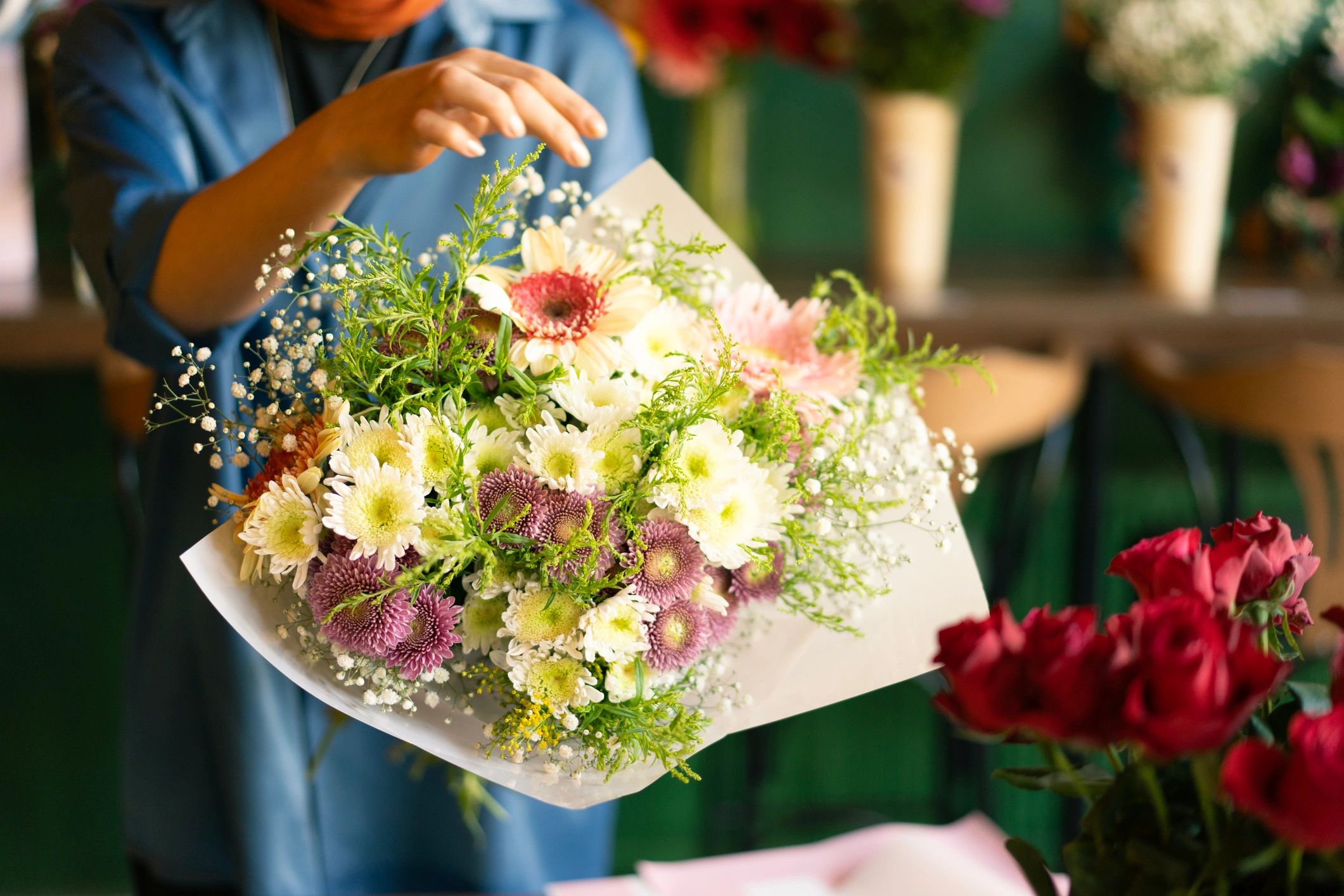 Florist preparing a bouquet in the shop