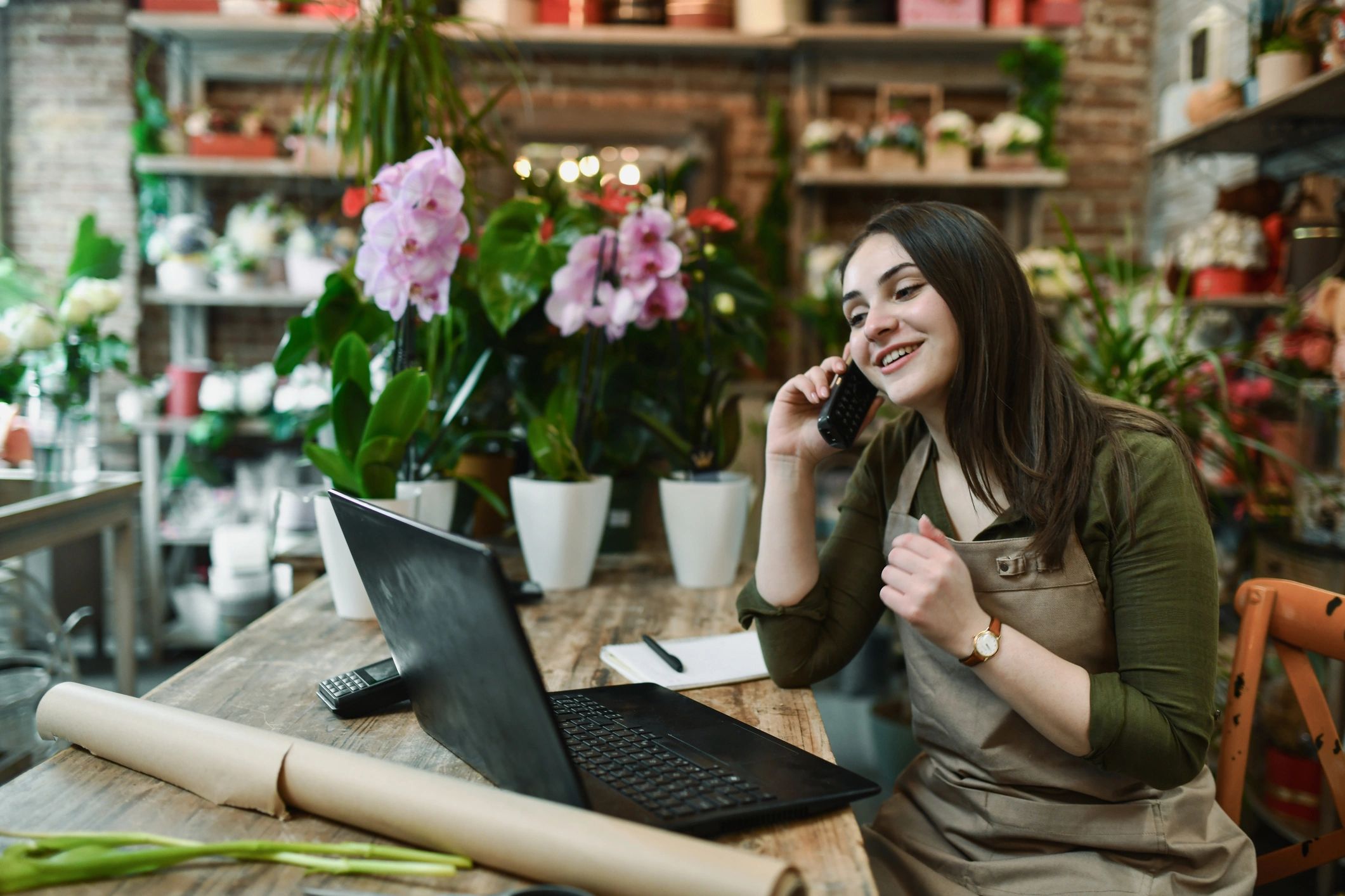 Florist on the phone in a flower shop